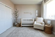 a baby's room with a white crib and rocking chair