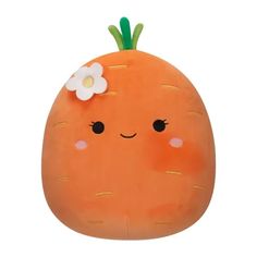 an orange stuffed animal with a flower on it's head, sitting in front of a white background