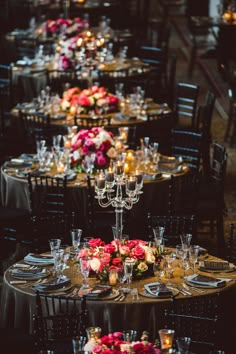 a long table is set up with candles and flower centerpieces for an elegant dinner