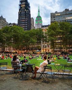 many people are sitting in the park at night