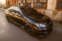 a black car parked in front of a building