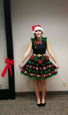 a woman in a christmas dress and santa hat