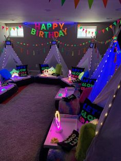 a room filled with lots of pillows and lights on the walls that say happy birthday