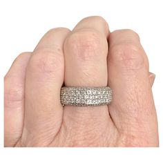 a person's hand with a wedding ring on it