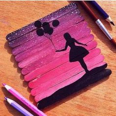 a pencil drawing of a girl with balloons on pink and purple painted wood planks