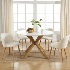 a white table with four chairs around it