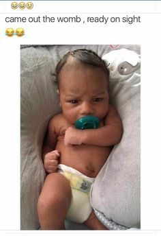 a baby with a pacifier in it's mouth laying on a pillow that says, i came out the womb, ready on sight