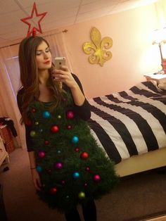 a woman taking a selfie in her bedroom decorated for christmas