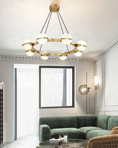 a living room filled with furniture and a round chandelier hanging from the ceiling