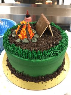 there is a cake with green frosting and brown icing on the top that looks like grass