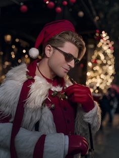 a man dressed as santa clause in front of a christmas tree wearing sunglasses and a red hat