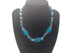 This necklace has medium blue beads and smaller light blue beads, It measures 16 inches long by .5 inches wide, The beads are glass. The blue will take your breath away! The beads are glass. Turquoise Glass Necklaces With Gemstone Beads, Turquoise Glass Beaded Necklaces For Jewelry Making, Blue Czech Glass Beaded Chain, Adjustable Blue Beaded Turquoise Necklace, Turquoise Glass Necklaces With Large Beads, Blue Round Beaded Glass Crystal Necklace, Blue Crystal Necklaces With Round Glass Beads, Blue Glass Beaded Necklaces As A Gift, Blue Czech Glass Necklace With Large Beads