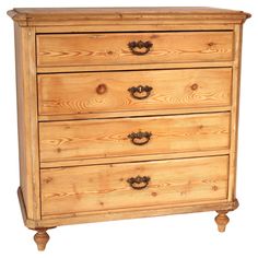 a wooden dresser with three drawers and two handles