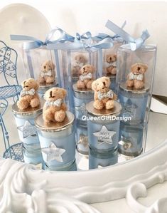 small teddy bears are sitting in blue cups