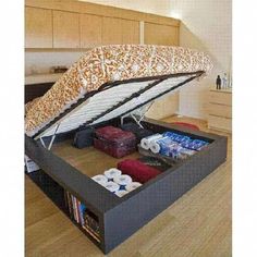 a bed with an open storage compartment underneath it