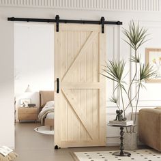 a living room with a couch, chair and sliding barn door