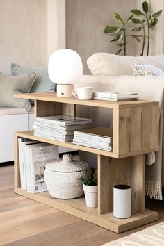 a living room with a couch, coffee table and bookshelf on the floor