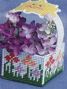 a basket with purple flowers and an umbrella