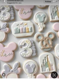 some cookies that are on top of a white surface with mickey mouse and other decorations