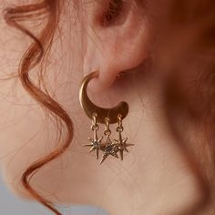 Get celestial guidance with the Star Multicharm Hoop Earrings, featuring a post-back golden hoop with dangling, crystal-detailed star charms. Celestial Earring Stack, Gold Celestial Jewelry, North Star Earrings, Gold Celestial Crystal Earrings With Moon Charm, Celestial Hoop Earrings With Star Charm, Celestial Star-shaped Hoop Earrings, Celestial Crescent Earrings With Star Charm, Gold Celestial Crystal Dangle Earrings, Brass Dangle Jewelry With Star Charm