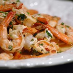 a plate full of shrimp and pasta with sauce