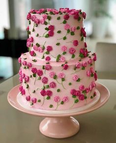 a three tiered cake with pink flowers on it