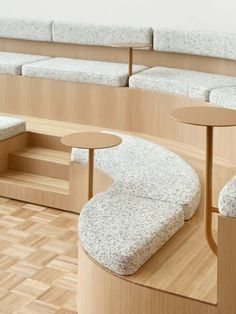 an empty room with several benches and tables on the floor in front of wooden walls