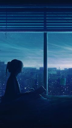 a person sitting on a bed in front of a window looking out at the city