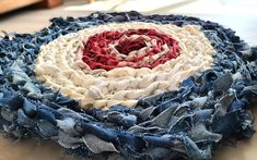 an old piece of cloth with red, white and blue colors on it sitting on a table