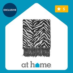 an image of a zebra print towel with the words at home on it's side