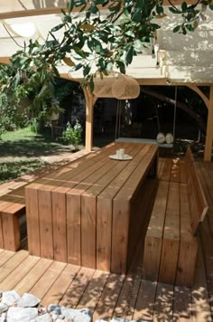 a wooden bench sitting on top of a wooden deck