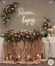 the wedding sign is lit up with candles and flowers