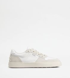 A sporty and sophisticated taste characterizes these sneakers with basketball-inspired upper, and side Tod's logo. Crafted in calfskin suede with smooth leather inserts, they come with a rubber outsole with embossed rubber pebbles. White Calf Leather Sneakers With Embossed Logo, White Calf Leather Sneakers For Streetwear, Luxury White High-top Sneakers With Embossed Logo, Designer White High-top Sneakers With Embossed Logo, Sporty Calf Leather High-top Sneakers With Perforations, High-top Calf Leather Sneakers With Perforations, White Calf Leather Sporty Sneakers, Sporty Sneakers With Embossed Logo In Calf Leather, Sporty White Calf Leather Sneakers