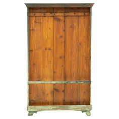 an old wooden cabinet with green paint and wood trimmings on the bottom shelf