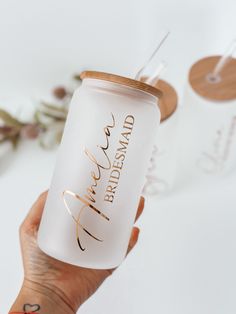 a person holding up a white and gold colored tumbler with the word bride on it