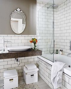 a bathroom with white tile walls and flooring