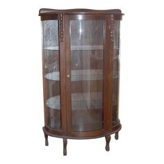 an antique display cabinet with glass doors and wood trimmings on the top shelf