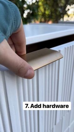 a person is holding the door handle on a white radiator with text that reads, 7 add hardware