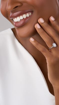 a close up of a person wearing a diamond ring