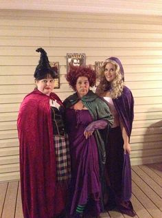 three women dressed in costumes posing for a photo