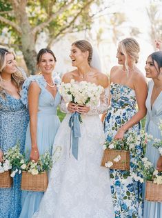 a group of women standing next to each other holding bouquets and flowers in their hands