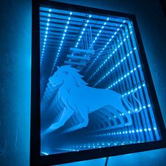 a neon sign with a lion on it in front of a blue wall and some lights