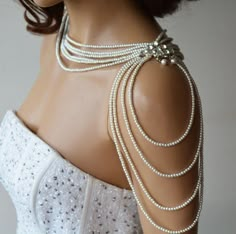 a mannequin with pearls on the back of it's neck and shoulder