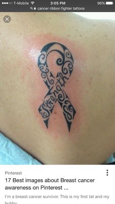 a black and white tattoo on the back of a woman's shoulder with an awareness ribbon