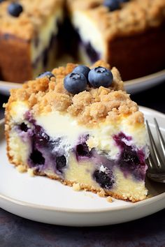 a slice of blueberry crumb cake on a plate with a fork next to it