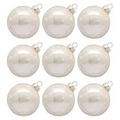 twelve white glass bauble ornaments with silver trimmings on each ornament