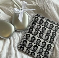 two eggs and a notebook with an image of the same person on them are laying next to each other