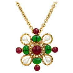 Beautiful vintage Chanel Gripoix necklace (circa 1980s) crafted in a yellow metal tone. Colored green and red glass, faux pearls and small crystals are set into the medallion. The long 21" chain features 7.5mm round links. The pendant is large in scale (3 inch diameter) and makes a great statement when worn. A great vintage Chanel piece for the collector or lover of everything Chanel. The necklace is in very good condition showing minimal wear. We have not cleaned it in order to preserve the pat Luxury Vintage Channel Set Jewelry, Chanel Pearl Necklace 1stdibs, Luxury Vintage Polished Beaded Necklaces, 80s Chanel, Vintage Chanel Jewelry, 80s Jewelry, Small Crystals, Chanel Jewelry, Green And Red