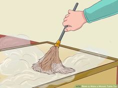 a person cleaning the floor with a dust mop in their hand and on top of it