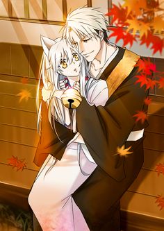 two anime characters hugging each other in front of autumn leaves